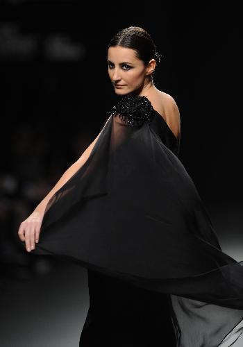 A model displays a creation by designer Elio Berhanyer at Cibeles Madrid Fashion Week in Madrid, capital of Spain, Feb. 19, 2010.