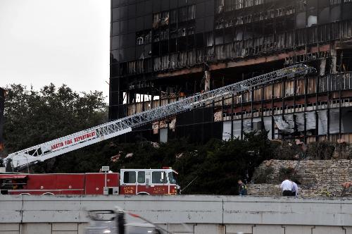 Photo taken on Feb. 18, 2010 shows the office building which was hit by a small aircraft crash in Austin, south U.S. state of Texas. A small plane crashed into the seven-story office building in Austin on Thursday, leaving at least one person dead, another missing and more than 10 others injured. Officials have ruled out the possibility of terrorist attack. [Chen Ruwei/Xinhua]