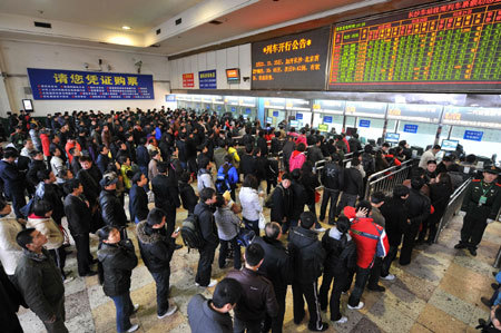 Passengers queue up to buy tickets at the railway station in Changsha, capital of Hunan Province, February 19, 2010. 