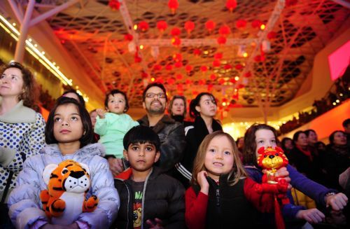 Children watch performances during a Chinese New Year Fair at the Westfield Shopping Center in London, February 19, 2010.