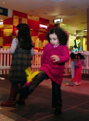 Children learn to play shuttlecock during a Chinese New Year Fair at the Westfield Shopping Center in London, February 19, 2010. 