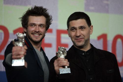 Russian actors Grigory Dobrygin (L) and Sergei Puskepalis applaud after receiving Silver Bears for Best Actor for their roles in 'Kak Ya Provel Etim Letom' (How I Ended This Summer) during the awards ceremony of the 60th Berlinale International Film Festival in Berlin on Feb. 20, 2010.