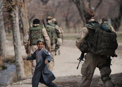 An Afghan boy looks back while Dutch soldiers patrol a village of Chora valley in the southern Afghan province of Uruzgan on January 21. The US envoy to NATO has urged the Netherlands to keep its troops in volatile southern Afghanistan, saying that 2010 is a pivotal year for the international military effort there. (AFP/File/Deshakalyan Chowdhury)