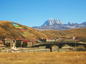 A monk makes his way back to the monastery on the south side of the river.