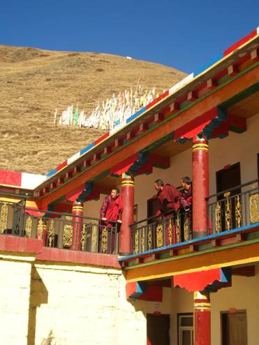 Monks engage in conversation at lunchtime at the Tagong monastery.