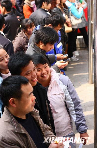 Migrant workers look at an information bulletin at a job fair in Liuzhou, Guangxi Zhuang Autonomous Region, on Feb. 20, 2010. Migrant workers went to the job fair for job opportunities on Friday after spending the Spring Festival holidays in their hometowns. 