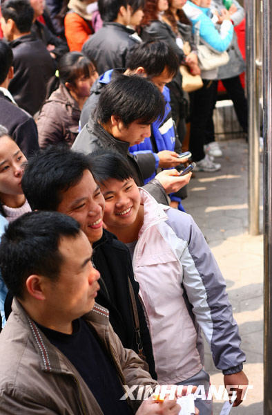 Migrant workers look at an information bulletin at a job fair in Liuzhou, Guangxi Zhuang Autonomous Region, on Feb. 20, 2010. Migrant workers go for job opportunities after spending the Spring Festival holidays in their hometowns.