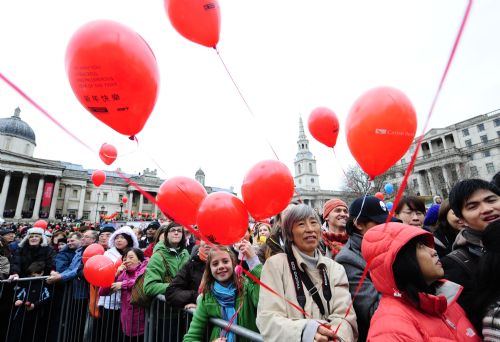 People watch the spectacular performances during a celebration of Chinese Lunar New Year on Trafalgar Square in London, capital of Britain, Feb. 21, 2010. Grand Chinese Lunar New Year celebrations were held in Trafalgar Square, Leicester Square and Chinatown in London on Sunday, providing a spectacular Chinese traditional festival experience to locals and visitors alike. 