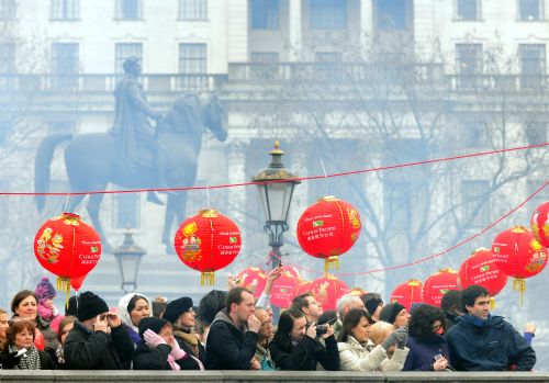 People watch the firecracker show during a celebration of Chinese Lunar New Year on Trafalgar Square in London, capital of Britian, Feb. 21, 2010. Grand Chinese Lunar New Year celebrations were held in Trafalgar Square, Leicester Square and Chinatown in London on Sunday, providing a spectacular Chinese traditional festival experience to locals and visitors alike.