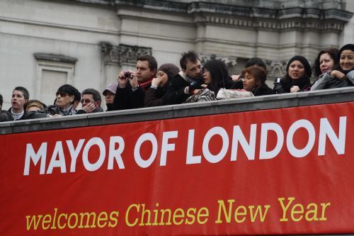 People watch the spectacular performances during a celebration of Chinese Lunar New Year on Trafalgar Square in London, capital of Britain, Feb. 21, 2010. Grand Chinese Lunar New Year celebrations were held in Trafalgar Square, Leicester Square and Chinatown in London on Sunday, providing a spectacular Chinese traditional festival experience to locals and visitors alike.