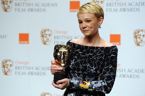 British actress Carey Mulligan poses for photographers with her British Academy of Film Award (BAFTA) for 'Leading actress' for her role in 'An Education' at the Royal Opera House in central London. The Oscar-nominated 24-year-old has blossomed into one of Hollywood's most sough-after actresses despite being rejected by three drama schools.