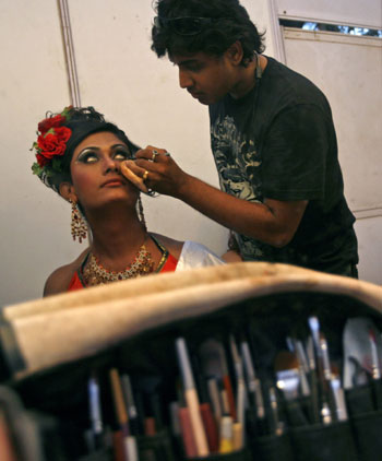 A contestant gets her make-up done before the finals of 'Indian Super Queen', a beauty pageant for the transgender community in Mumbai February 21, 2010. Some 400 contestants from the transgender community across the country participated in the pageant. 