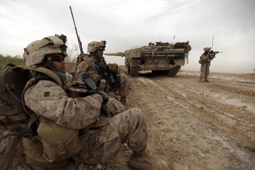 U.S. marines clear Improvised Explosive Devices (IEDs) from a main route on the outskirts of Marjah on February 21.