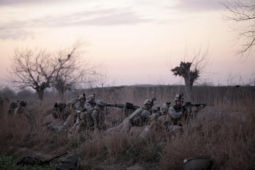 U.S. Marines from Bravo Company, 1st Battalion, 6th Marines, take up position in the town of Marjah, in Nad Ali district, Helmand province, February 13, 2010. U.S.-led NATO troops launched a crucial offensive on Saturday against the Taliban&apos;s last big stronghold in Afghanistan&apos;s most violent province and were quickly thrown into a firefight with the militants. [Xinhua] 