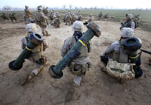 U.S. Marines from Bravo Company, 1st Battalion, 6th Marines, take a break in the town of Marjah, in Nad Ali district, Helmand province, February 13, 2010. U.S.-led NATO troops launched a crucial offensive on Saturday against the Taliban&apos;s last big stronghold in Afghanistan&apos;s most violent province and were quickly thrown into a firefight with the militants. [Xinhua]