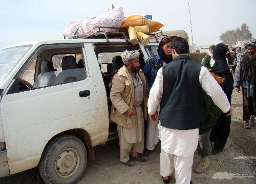 Afghans are checked by policemen when they leave Marjah district in Helmand province, southern Afghanistan, Feb. 13, 2010. Hours after launching major offensive by 15,000 NATO and Afghan soldiers against Taliban militants in Marjah district of southern Helmand province, Afghan Minister of Defense Abdul Rahim Wardak said that several areas have been captured and clash for control of Marja Bazaar is going on. [Stringer/Xinhua] 