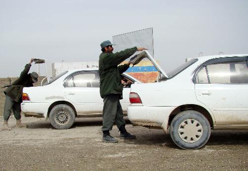 Afghan policemen check vehicles going out of Marjah district in Helmand province, southern Afghanistan, Feb. 13, 2010. Hours after launching major offensive by 15,000 NATO and Afghan soldiers against Taliban militants in Marjah district of southern Helmand province, Afghan Minister of Defense Abdul Rahim Wardak said that several areas have been captured and clash for control of Marja Bazaar is going on. [Stringer/Xinhua] 