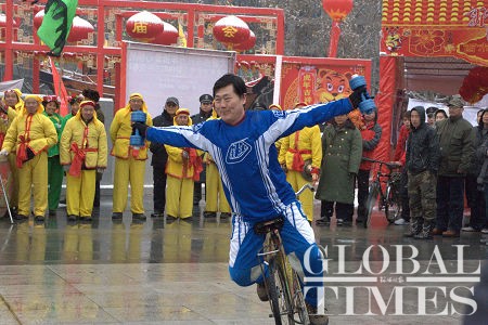 The performer performing the balancing acts while riding his ordinary bicycle. Photo: Deborah Howard