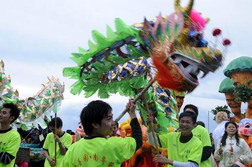 Members of a Chinese art troupe perform traditional dragon dance during a parade of the 126th edition of the Nice carnival in Nice, France, on Feb. 21, 2010. The 126th Nice Carnival which takes place from Feb. 12 till Feb. 28 came to a climax on Sunday. A total of 20 floats joined the parade and lots of people took part in it.