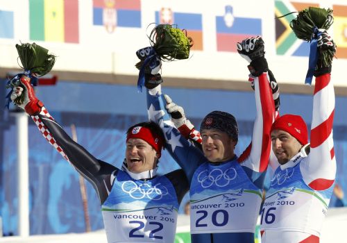 Gold medallist Bode Miller (C) of the U.S. celebrates with silver medallist Ivica Kostelic (L) of Croatia and bronze medallist Silvan Zurbriggen of Switzerland at the flower ceremony for the men's Alpine Skiing Super Combined race at the Vancouver 2010 Winter Olympics in Whistler, British Columbia, February 21, 2010. 