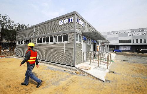  A worker walks past an environment friendly public toilet at 2010 World Expo Site in east China's Shanghai, Feb. 22, 2010. More than thirty pre-feb public toilets serving about 8,000 visitors at a time are installed for the 2010 Shanghai World Expo. The toilets, using water supplied partly by rainwater collected in the Sunshine Valley, are adjustable acording to the ratio of service area for female and male users. [Xinhua]
