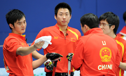 China's Xu Xiaoming, Liu Rui, Li Hongchen and Zang Jialiang (from L to R) discuss during the men's curling round robin match against the United States at the 2010 Winter Olympic Games in Vancouver, Canada, Feb. 22, 2010. China won 11-5. (Xinhua/Chen Kai)
