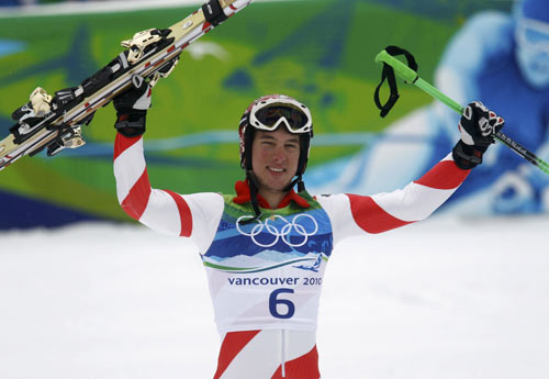 Switzerland's Carlo Janka lifts up his skis after competing in the second run of the men's alpine skiing giant slalom event at the Vancouver 2010 Winter Olympics in Whistler, British Columbia, February 23, 2010. 