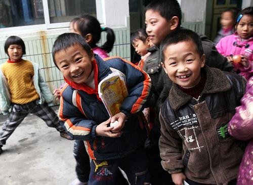Children in the Yucai Primary School of Pudong District in Shanghai take a break between classes. In 2010 Shanghai will become the first Chinese city to provide free education to all school-age children of migrant workers, through more government investment in facilities and teachers. 