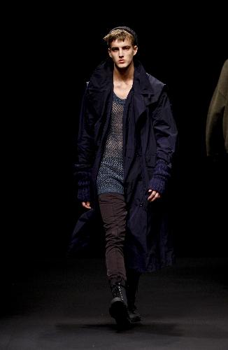 A model presents a creation of Topman design on the last day of the London Fashion Week 2010 Autumn/Winter Collection in London, Britain, Feb. 24, 2009.