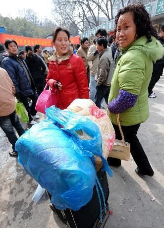 Migrant workers look for opportunities in a job fair in Nanjing, Jiangsu Province, on February 19, 2010. 