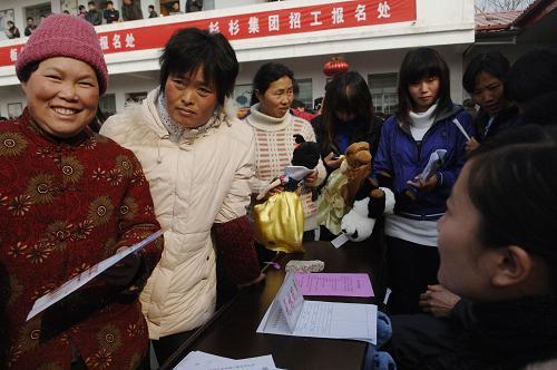 Migrant workers look for opportunities in a job fair in Funan County, Anhui Province, on February 23, 2010. 