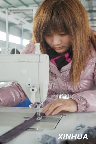 Wang Chunyan, a migrant worker, works in a company Huaiyang County, Henan Province, on February 22, 2010. 