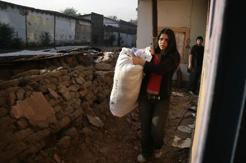 A woman transfers her belongings after a 8.8-magnitude earthquake in Santiago, capital of Chile, Feb. 27, 2010. (Xinhua