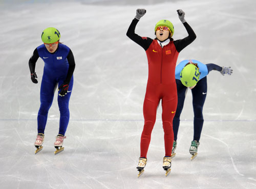 China's Wang Meng (C) reacts after the women's 1000m final of short track speed skating at the 2010 Winter Olympic Games in Vancouver, Canada, Feb. 26, 2010. (Xinhua/Yang Lei) 