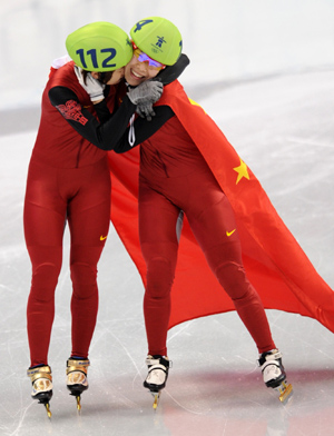 China's Wang Meng (L) celebrates with her teammate Zhou Yang after the women's 1000m final of short track speed skating at the 2010 Winter Olympic Games in Vancouver, Canada, Feb. 26, 2010. Wang Meng won the gold medal with 1 minute and 29.213 seconds. (Xinhua/Yang Lei) 