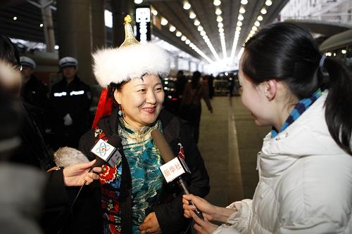 A member of the 11th National Committee of the Chinese People's Political Consultative Conference (CPPCC) from north China's Inner Mongolia Autonomous Region arrives in Beijing, March 1, 2010.