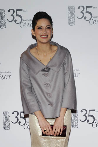 French actress Marion Cotillard poses as she arrives to attend the Cesar Awards ceremony in Paris February 27, 2010.