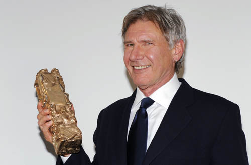 U.S. actor Harrison Ford poses with his honorary Cesar award during the Cesar Awards ceremony in Paris February 27, 2010.