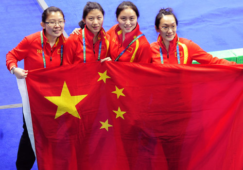 China's Wang Bingyu, Liu Yin, Yue Qingshuang and Zhou Yan (from L to R) celebrate with the national flag after the women's curling bronze medal match against Switzerland at the 2010 Winter Olympic Games in Vancouver, Canada, Feb. 26, 2010. China won the bronze medal after defeating Switzerland 12 -6. (Xinhua/Chen Xiaowei) 
