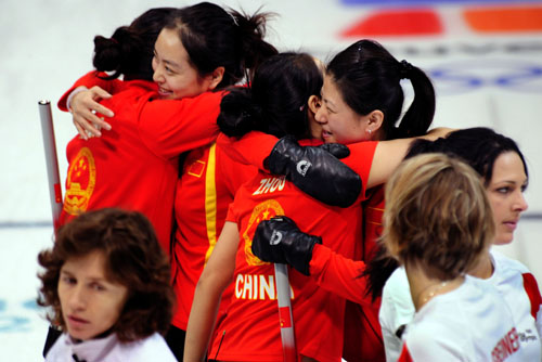 China's Wang Bingyu, Yue Qingshuang, Zhou Yan and Liu Yin (from L to R) hug to celebrate after the women's curling bronze medal match with Switzerland at the 2010 Winter Olympic Games in Vancouver, Canada, Feb. 26, 2010. [Xinhua/Chen Xiaowei]