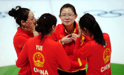 China's Zhou Yan, Yue Qingshuang, Wang Bingyu and Liu Yin react after the women's curling bronze medal match with Switzerland at the 2010 Winter Olympic Games in Vancouver, Canada, Feb. 26, 2010. [Xinhua/Chen Xiaowei]