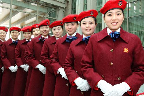 Attendants from Beijing Conference Center welcomes members of the 11th National Committee of the Chinese People's Political Consultative Conference (CPPCC) at the airport in Beijing, China, March 1, 2010. (Xinhua 