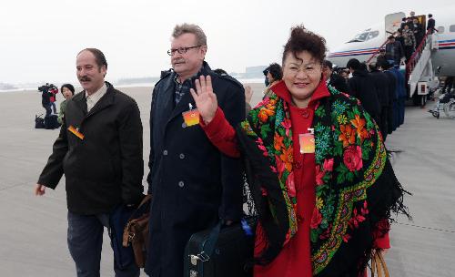 Members of the 11th National Committee of the Chinese People's Political Consultative Conference (CPPCC) from northwest China's Xinjiang Uygur Autonomous Region arrive in Beijing, capital of China, March 1, 2010. (Xinhua