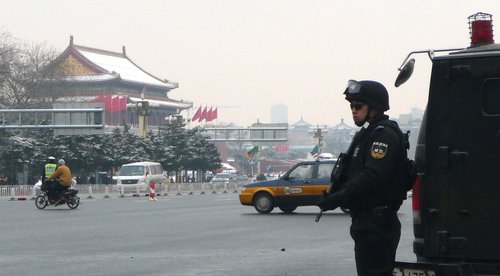 A SWAT policeman stands guard on Beijing's Chang'an Avenue, March 1, 2010. Beijing has intensified police numbers to ensure public safety during the upcoming annual plenary sessions of the National Committee of the Chinese People's Political Consultative Conference and China's National People's Congress, which are set to start on March 3 and March 5 respectively. [China Daily]