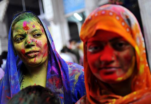 Women with their faces smeared in color are seen during the celebrations of Holi, at a temple in New Delhi, India, Mar. 1, 2010. The tradition of Holi, also known as Festival of Colors, marking the beginning of spring was celebrated all over India. [Xinhua]