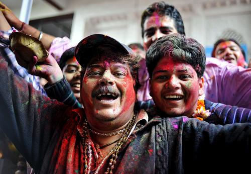 Men with their faces smeared in color are seen during the celebrations of Holi, at a temple in New Delhi, India, Mar. 1, 2010. The tradition of Holi, also known as Festival of Colors, marking the beginning of spring was celebrated all over India. [Xinhua]