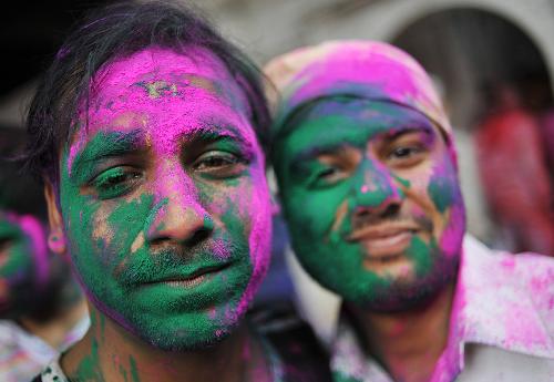 Men with their faces smeared in color are seen during the celebrations of Holi, at a temple in New Delhi, India, Mar. 1, 2010. The tradition of Holi, also known as Festival of Colors, marking the beginning of spring was celebrated all over India. [Xinhua]