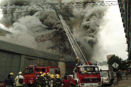Firemen fight a fire in a building damaged by a major earthquake in Concepcion March 1, 2010. Chile&apos;s government scrambled on Monday to provide aid to thousands of homeless people in coastal towns devastated by a massive earthquake and tsunamis, as 10,000 troops patrolled to quell looting. [Xinhua] 