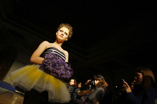 A student presents a creation made of recyclable materials during a fashion show in Bucharest March 1, 2010.