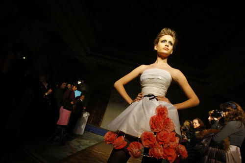 A student presents a creation made of recyclable materials during a fashion show in Bucharest March 1, 2010. 